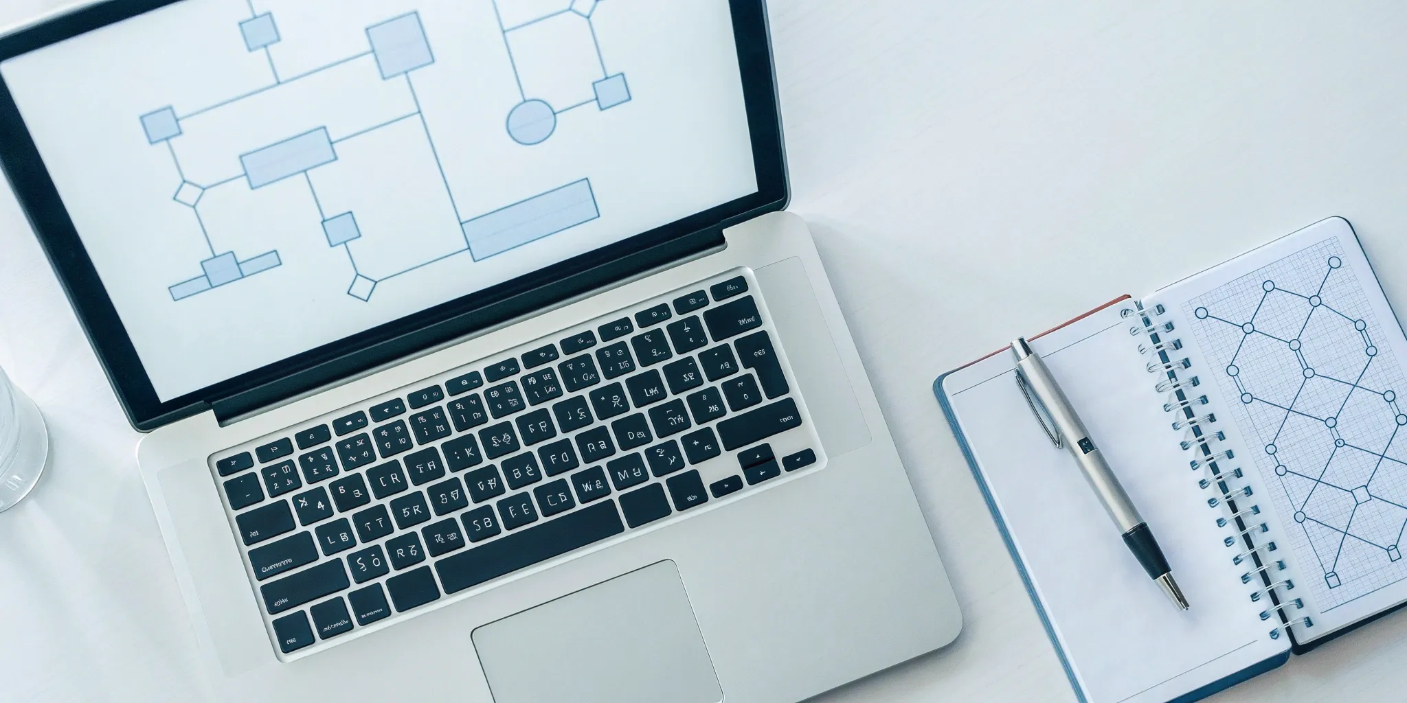 A flowchart on a laptop planning the steps for an ASC 606 implementation for SaaS.