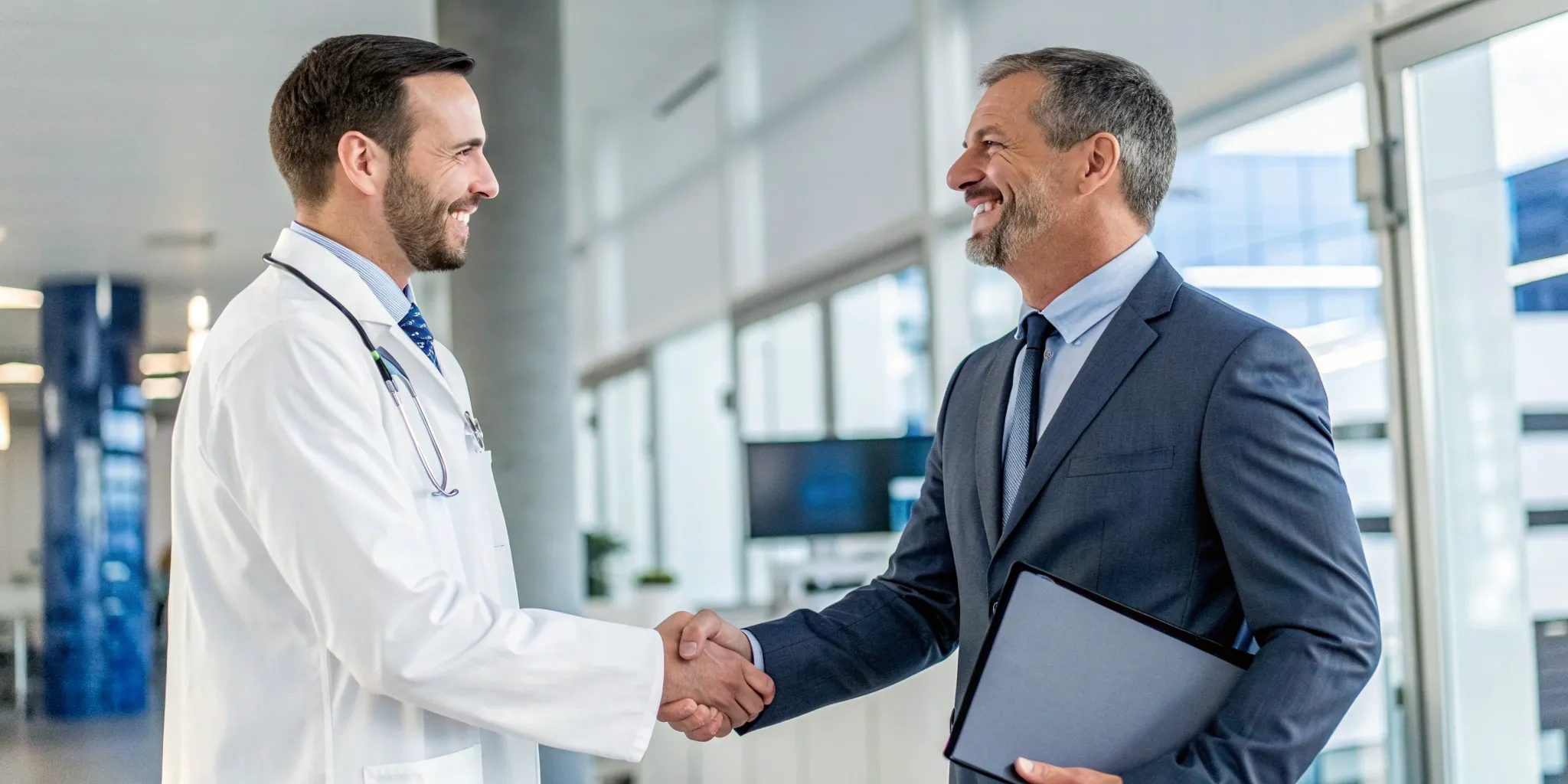 Doctor shaking hands with a consultant for healthcare audit and compliance services.