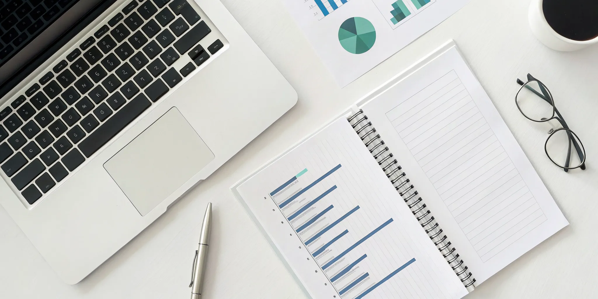 Organized desk with a laptop and financial documents for business tax compliance.