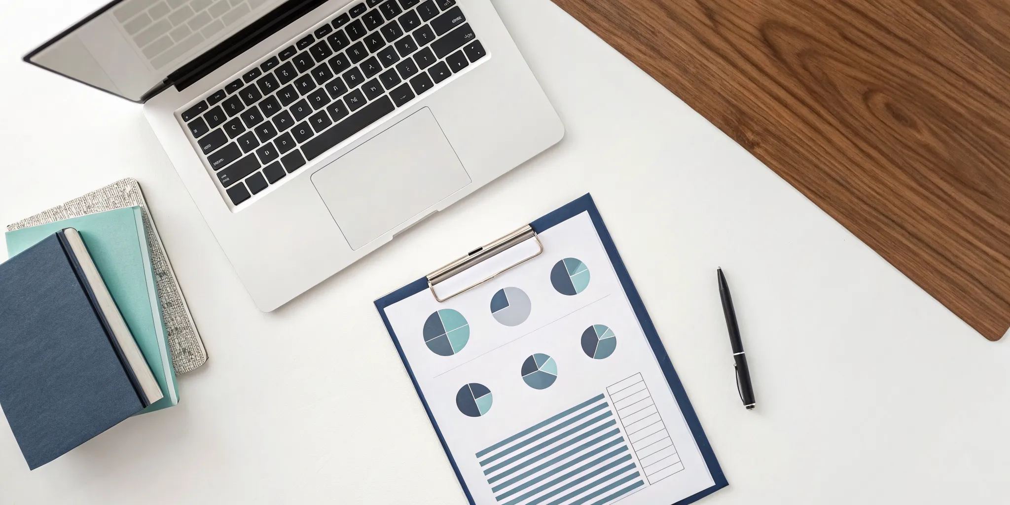 Laptop and tax documents on a desk for filing business taxes for an LLC.